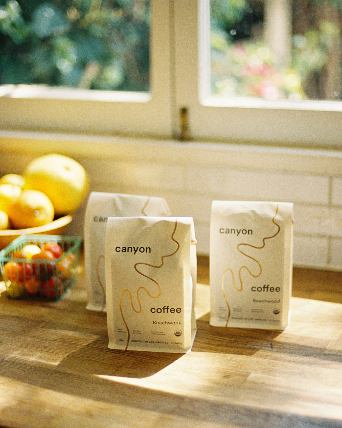 Bags of Canyon Coffee on a wood counter in Los Angeles